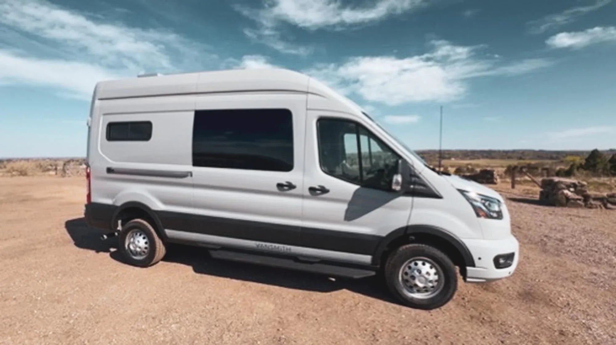 2026 conversion van - The exterior of the camper van conversion features a sleek, silver Ford Transit
