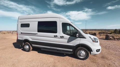 2026 conversion van - The exterior of the camper van conversion features a sleek, silver Ford Transit