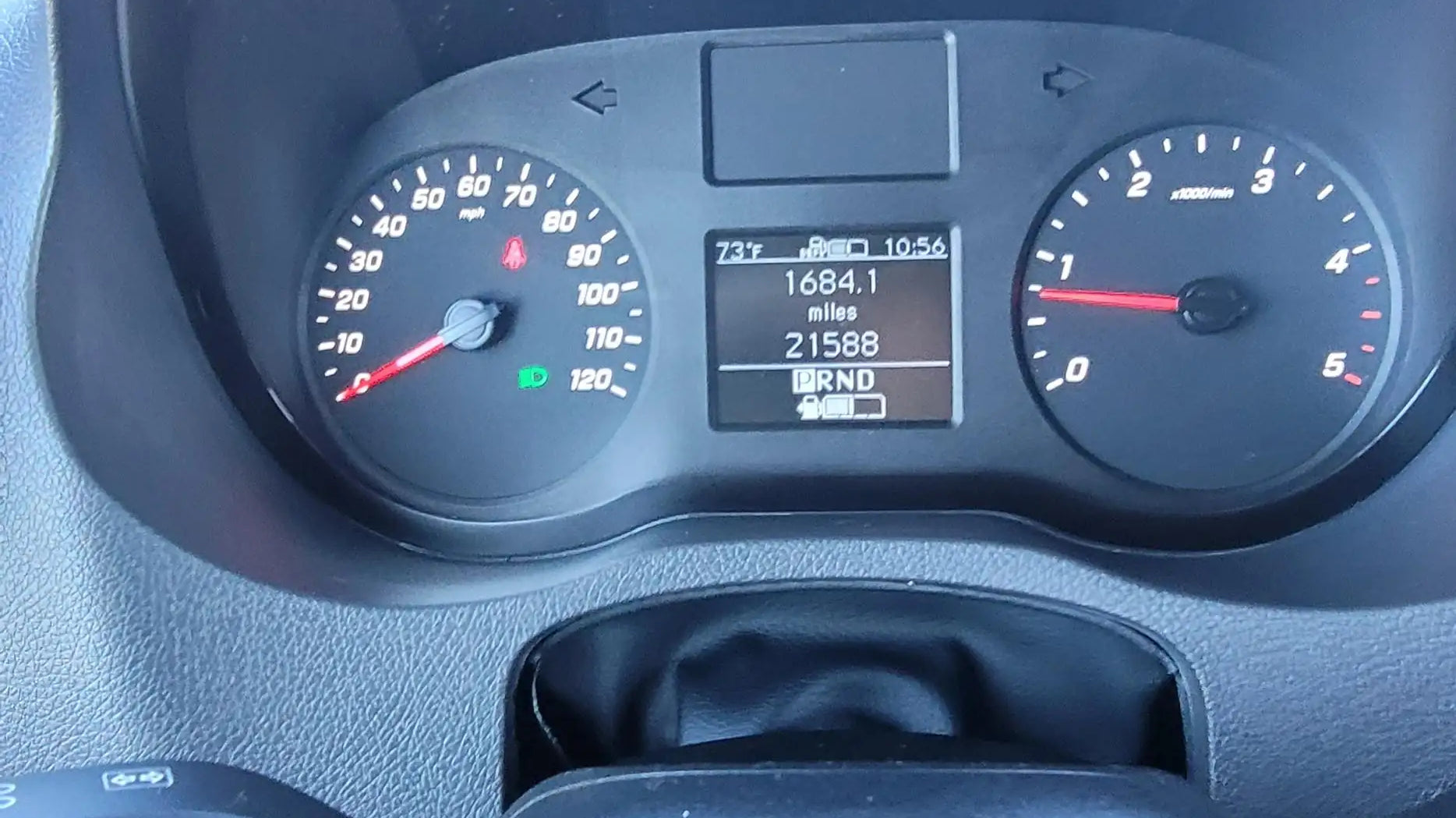 3k in miles - The most prominent feature in the photo is the vehicle's dashboard, which displa