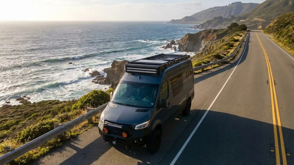Best Places to Snorkel in the U.S. - Camper van parked on a coastal highway above the Pacific at sunset