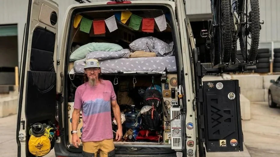 camper van philosophy - The most prominent feature in the photo is the open rear doors of the camper van