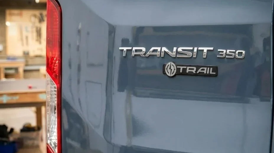 ford transit conversion kit - The most prominent feature in this photo is the rear exterior of a Ford Transit