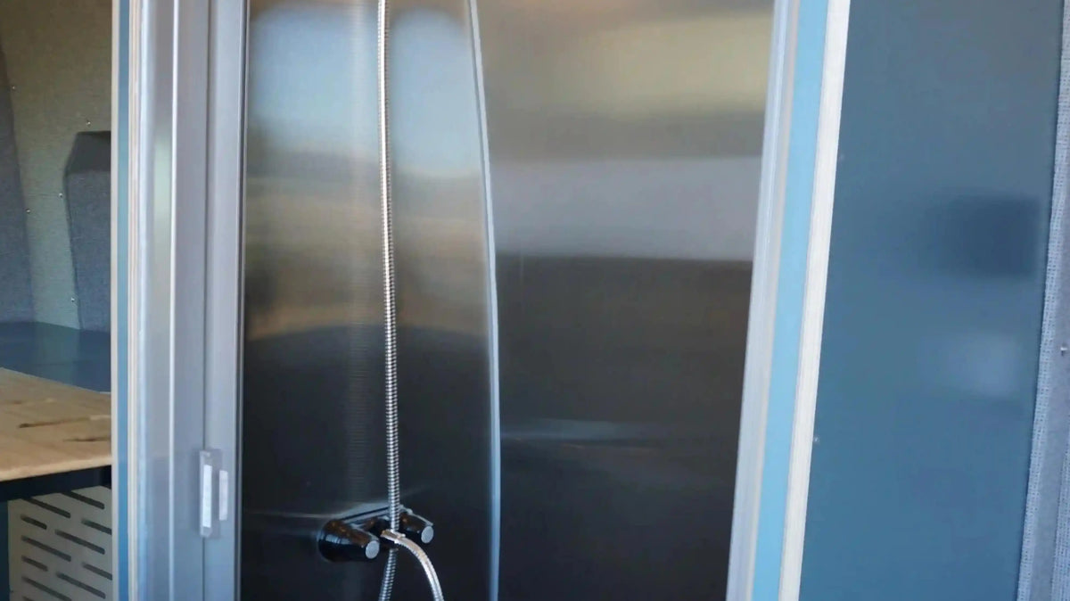 Natural Shampoo for Camping - The shower stall with a handheld showerhead inside a Vansmith camper van