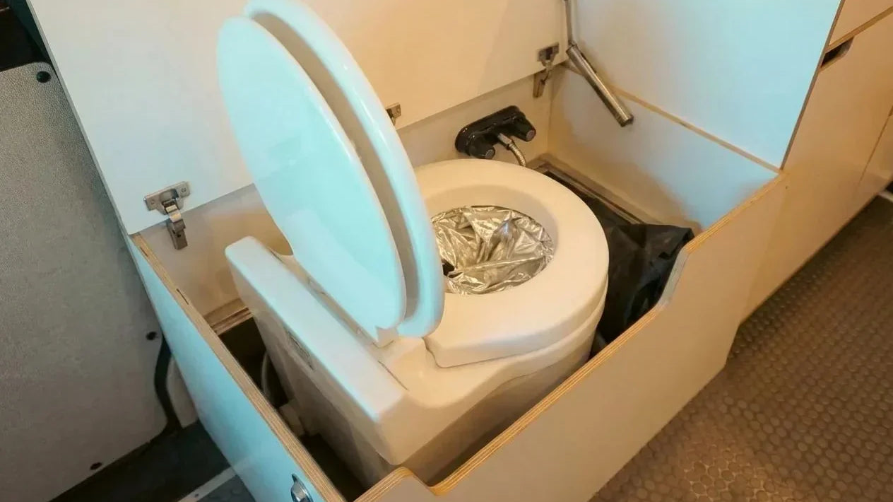 pop up camper with toilet - The most prominent feature in this photo is the compact toilet unit, designed fo