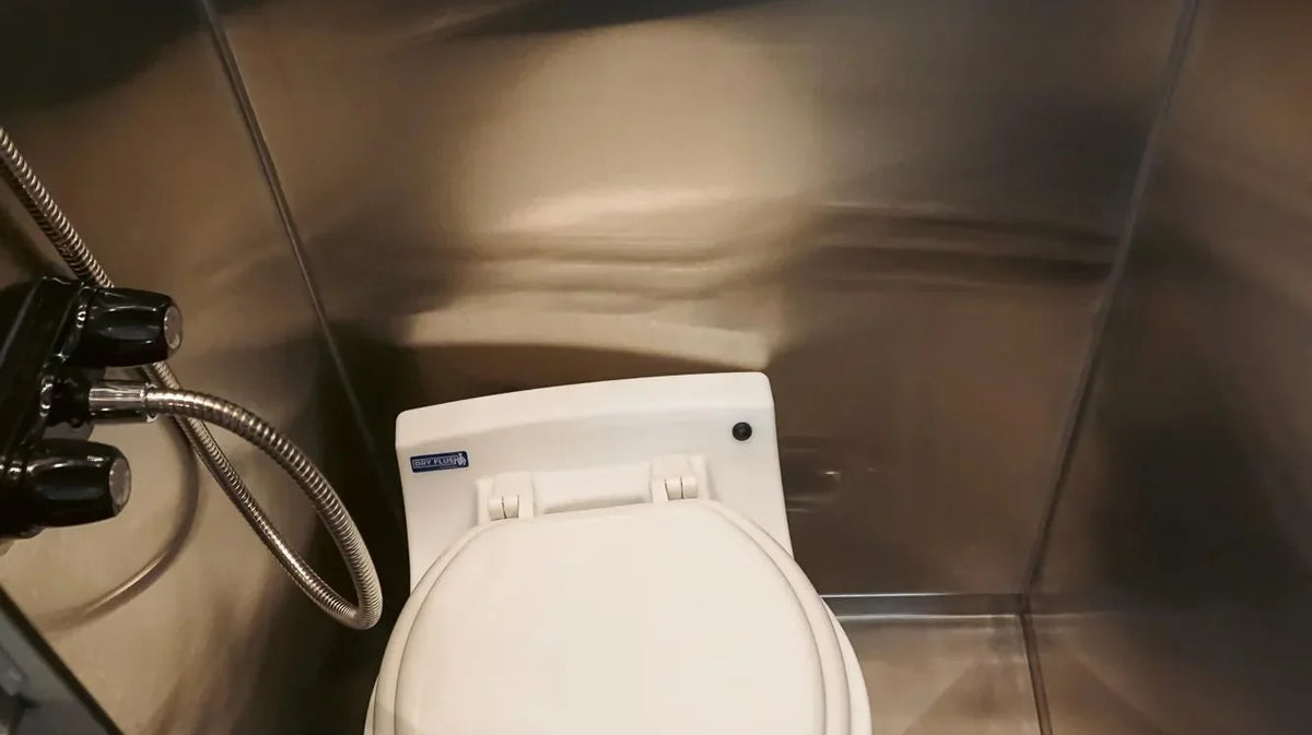 small rvs - The prominent feature in this camper van photo is the compact toilet, which is w