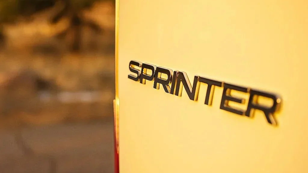 sprinter minivan - The most prominent feature in this photo is the "Sprinter" logo on the rear of a