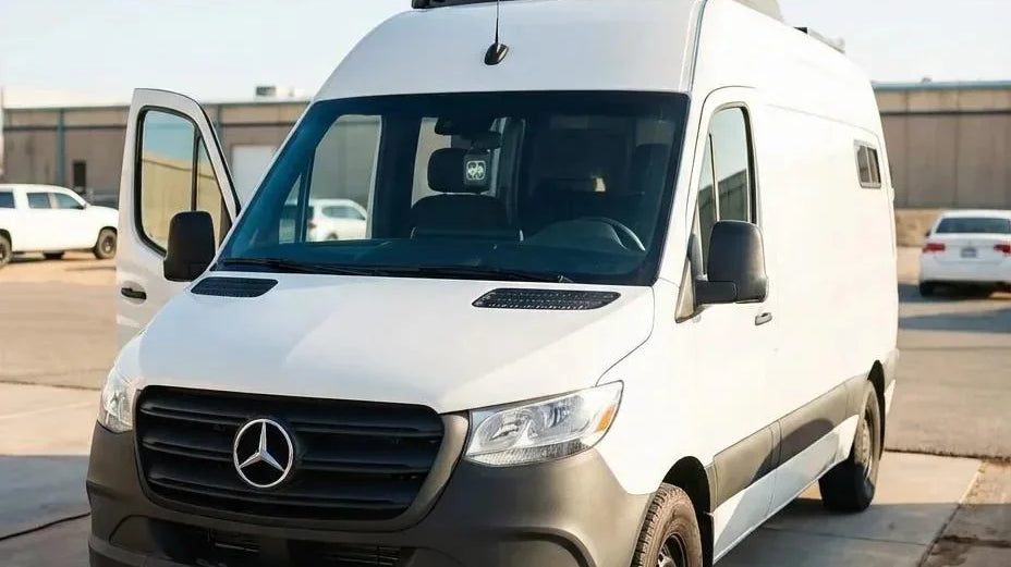 sprinter passenger van - The most prominent feature in the photo is the sleek exterior of a white Mercede