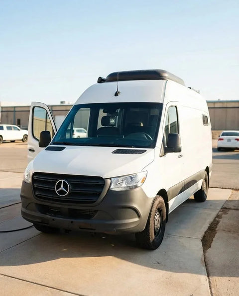 sprinter passenger van - The most prominent feature in the photo is the sleek exterior of a white Mercede