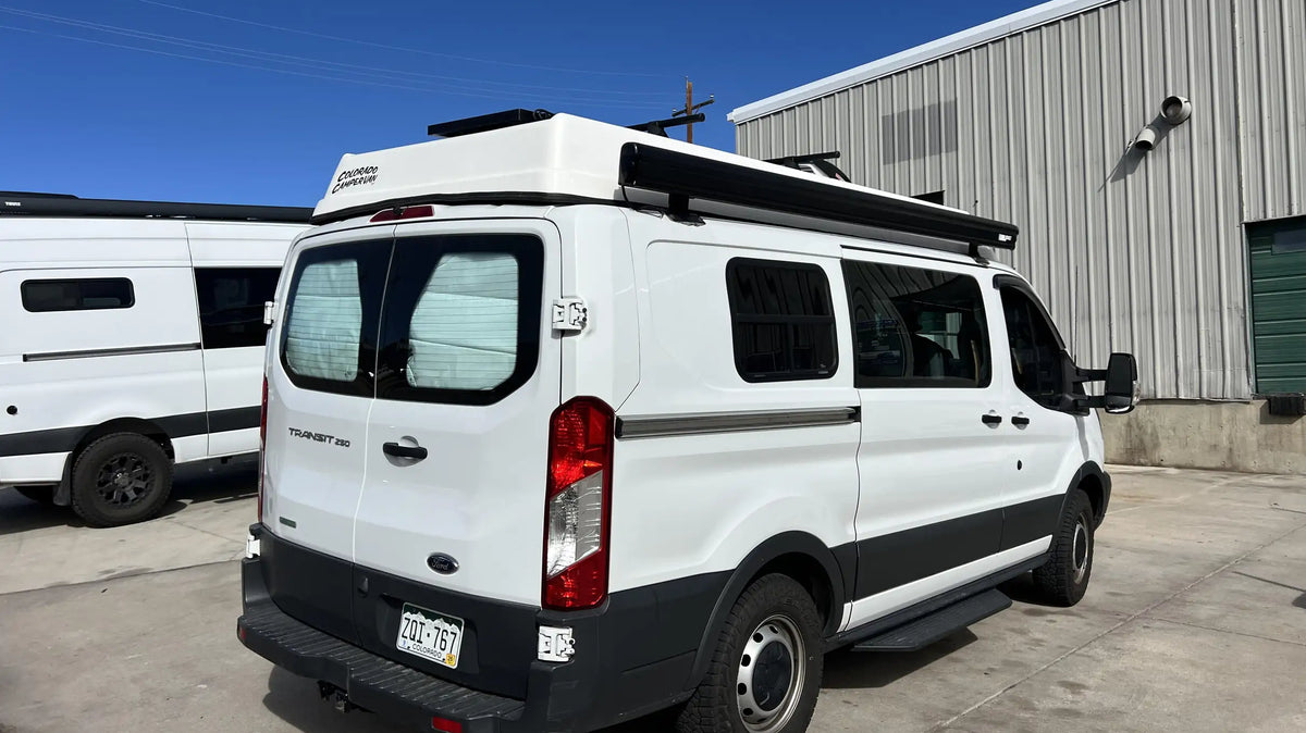 van conversion companies colorado - This image shows a white Ford Transit 250 camper van conversion named "Colorado