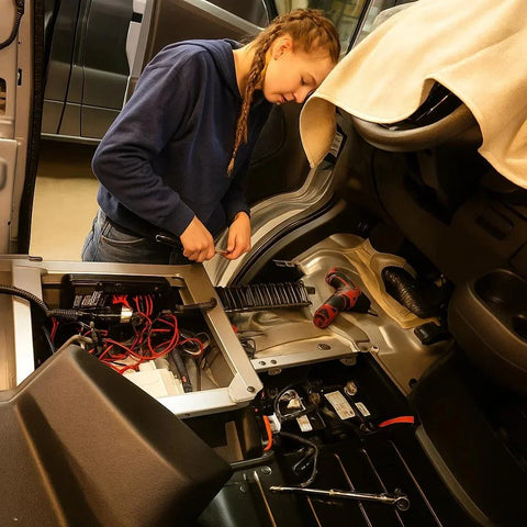 van conversion installs - The most prominent feature in the photo is the exposed electrical system and bat