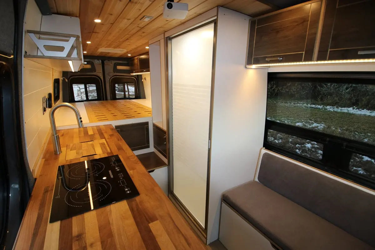 Luxury Interior of The Vansmith Duo S Van Conversion with Shower Stall and Polished Wood Finish