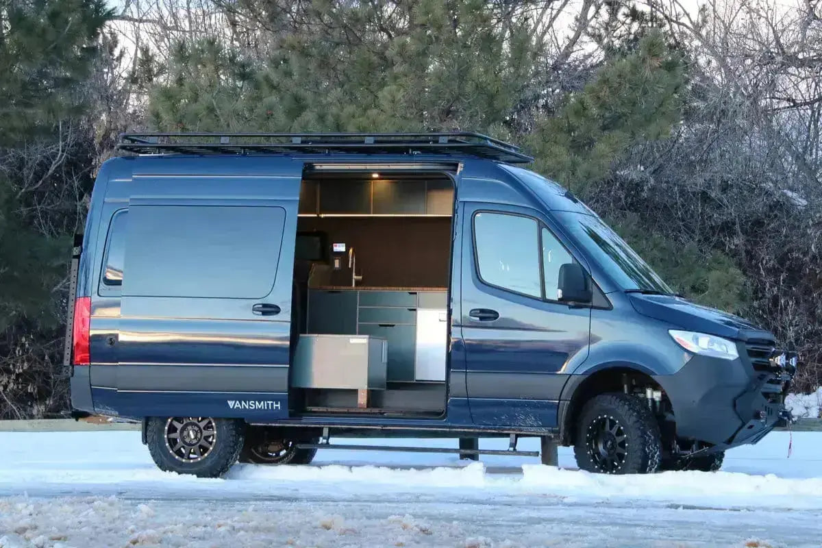 Side Exterior View of The Vansmith Duo Affordable Sprinter Camper Van Conversion for Couples with Snow Outside