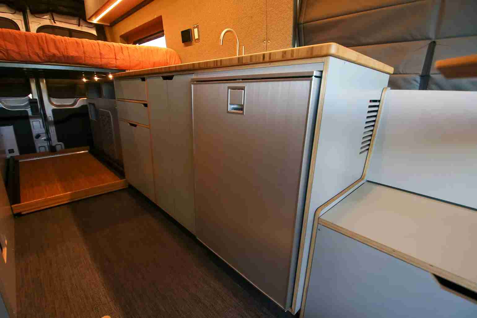 Close-Up of Kitchen Galley in Ford Transit Camper Van Conversion by The Vansmith with Sink and Refrigerator