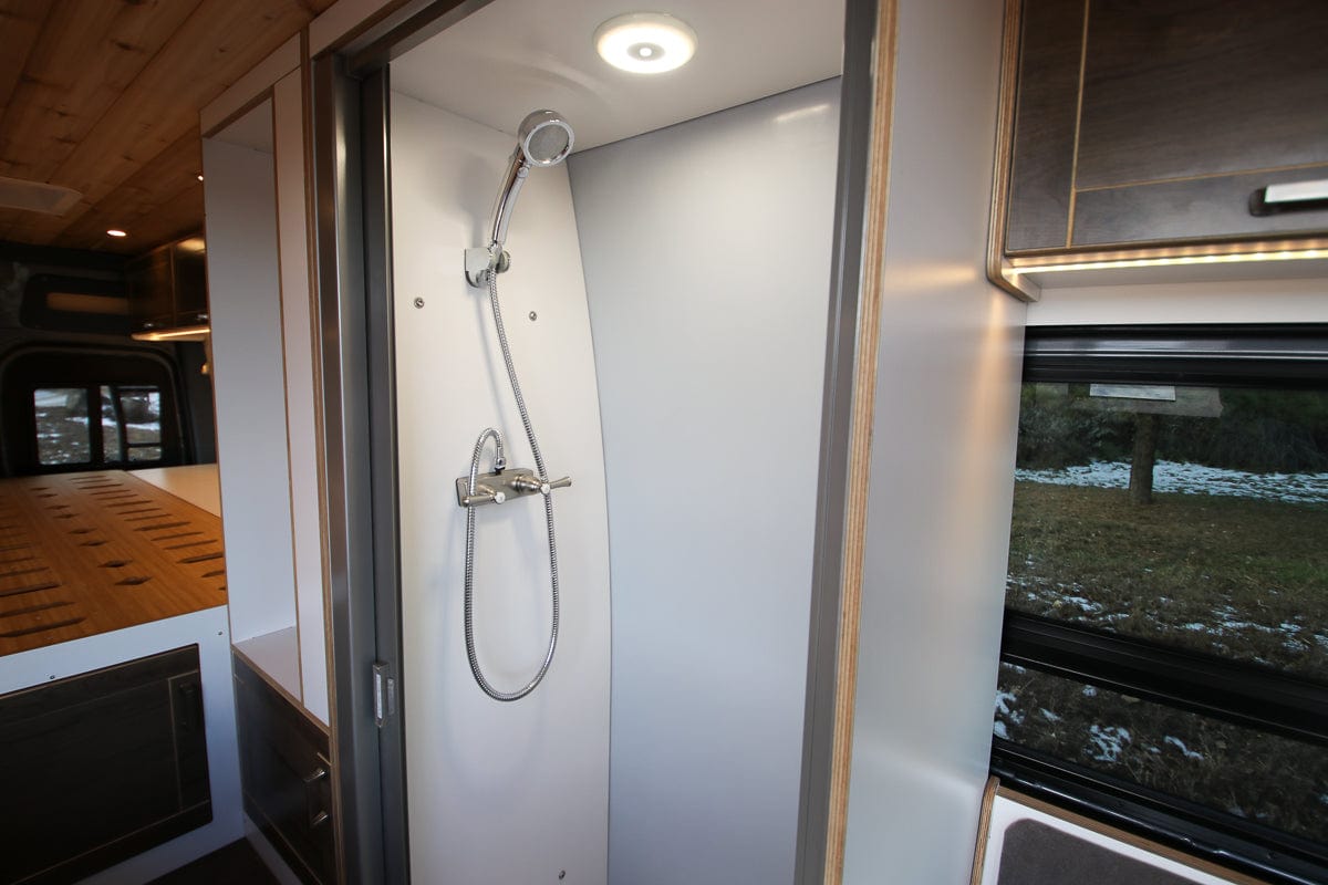Shower in Sprinter Van Conversion with Enclosable Stall, Handheld Showerhead and Lighting Built by The Vansmith