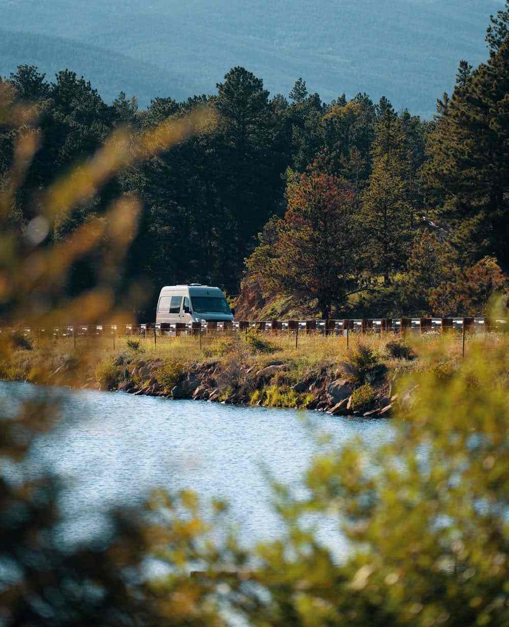 Eco Van Conversion by The Vansmith Viewed from Afar on Road Across Lake