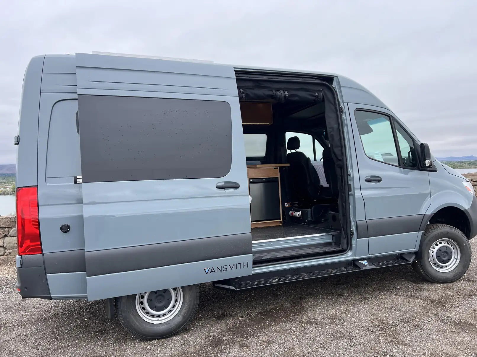 inside of a sprinter van - This image shows a light blue Mercedes-Benz Sprinter van converted by The Vansmi