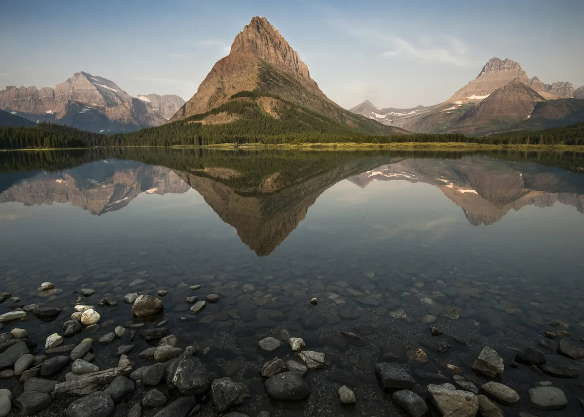 Montana Camping - Grinnell Point reflected in Swiftcurrent Lake at sunrise near Many Glacier, Glacier National Park