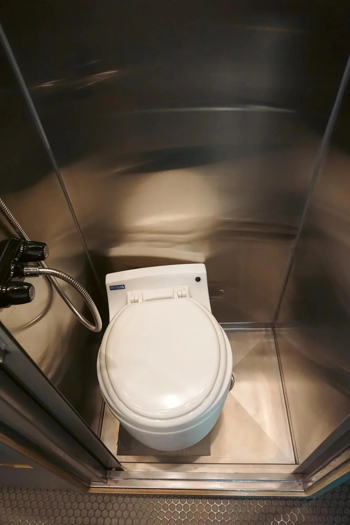small rvs - The prominent feature in this camper van photo is the compact toilet, which is w
