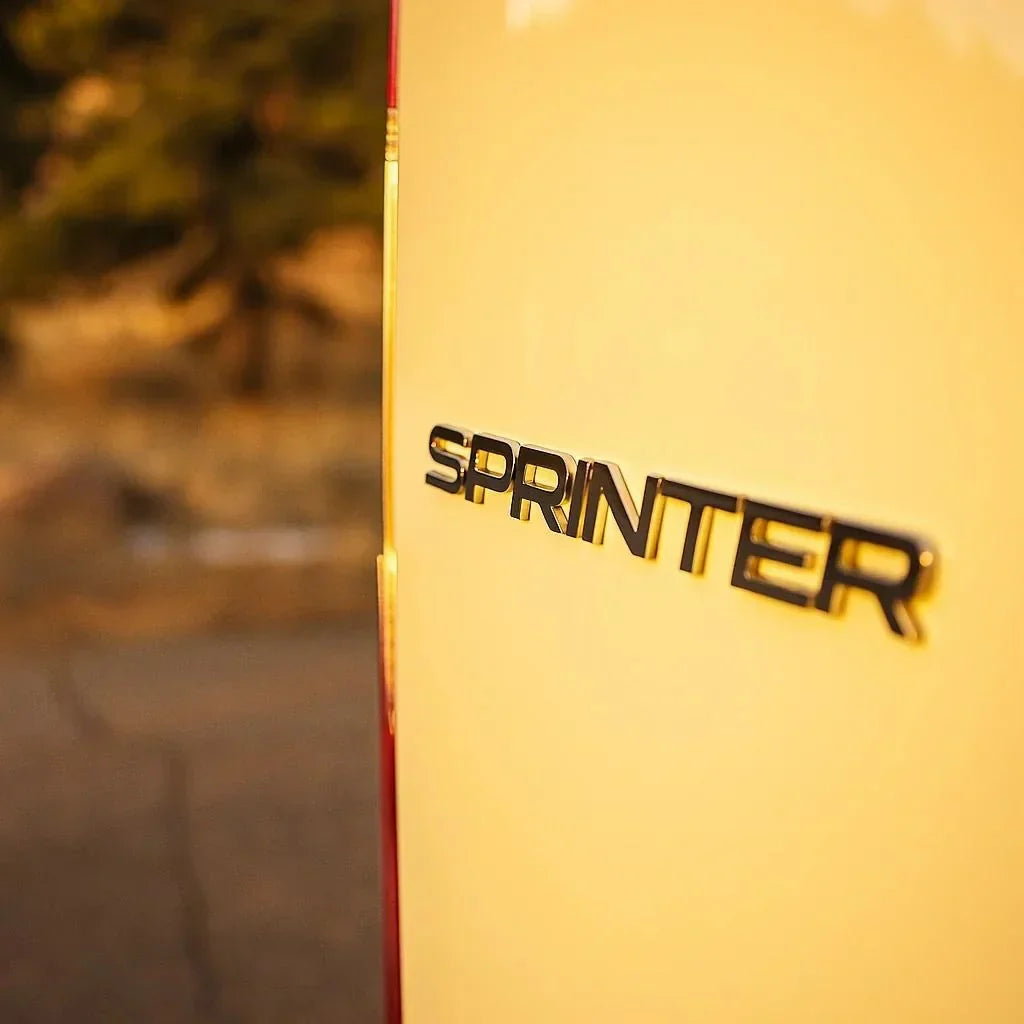 sprinter minivan - The most prominent feature in this photo is the "Sprinter" logo on the rear of a
