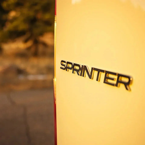 sprinter minivan - The most prominent feature in this photo is the "Sprinter" logo on the rear of a