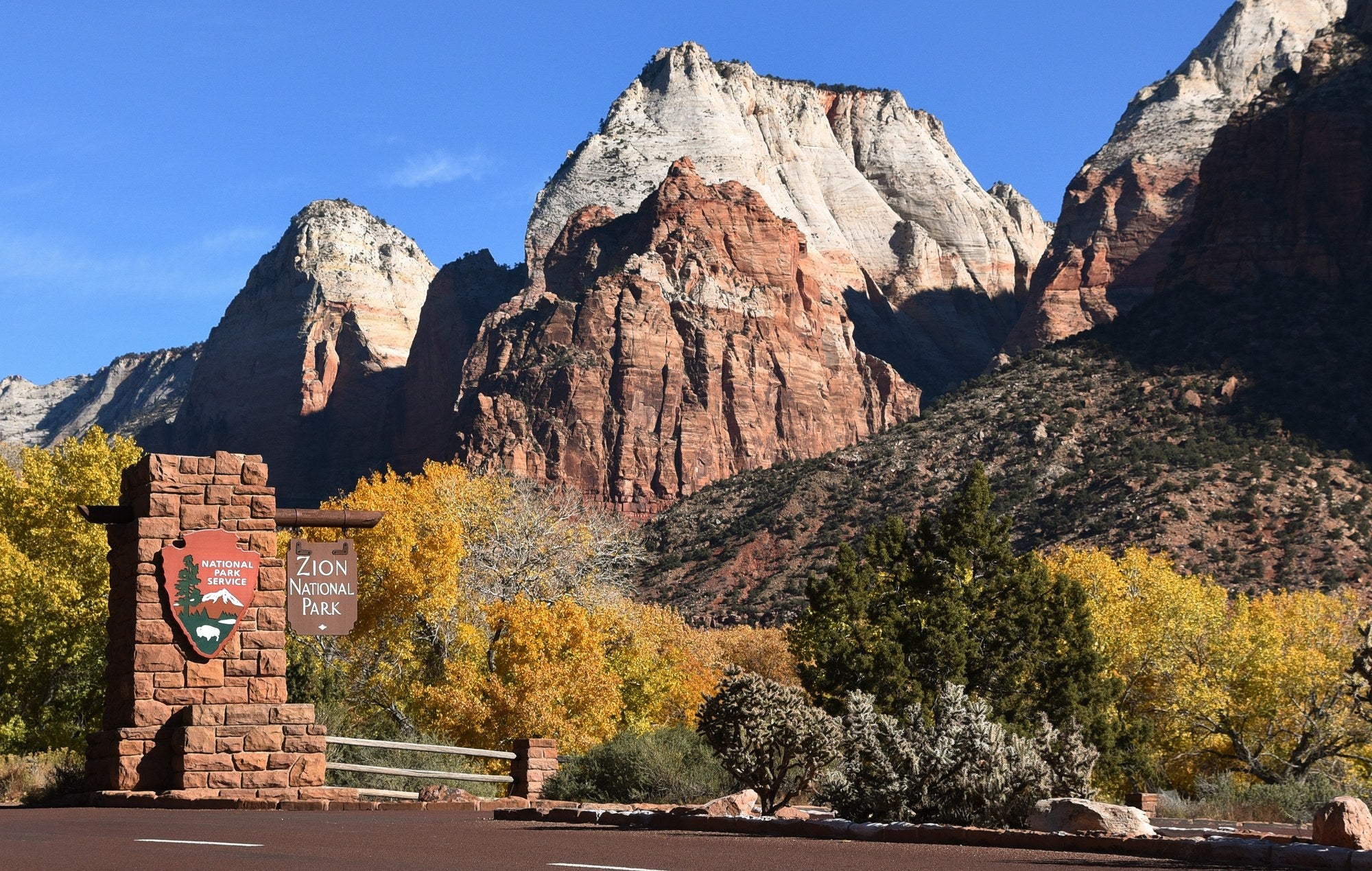 Las Vegas to Zion National Park - Zion National Park entrance sign with the Twin Brothers peaks rising behind it