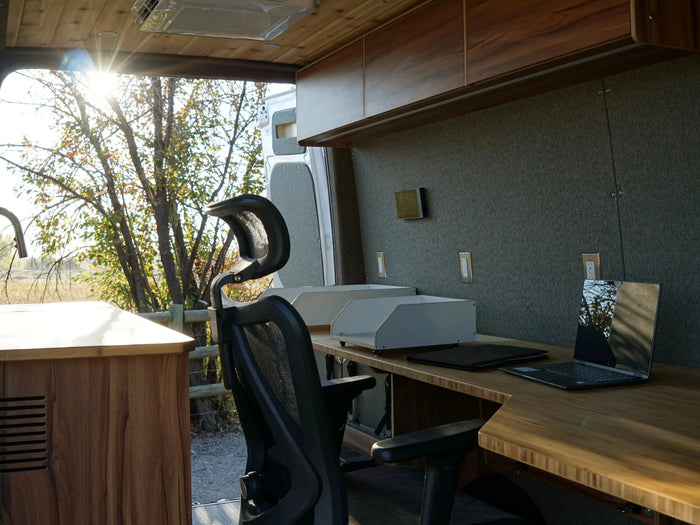 Office desk and chair inside the Grind - The Office Van looking out the open side door - The Vansmith