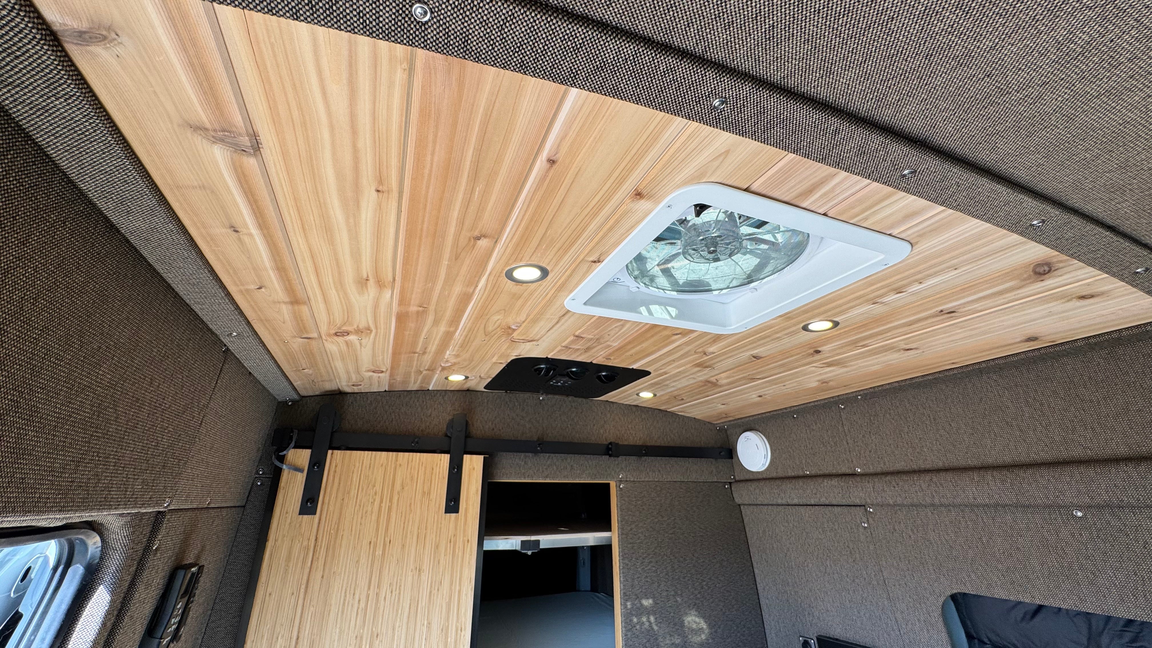 Cedar ceiling with vent fan and Nomadic A/C panel