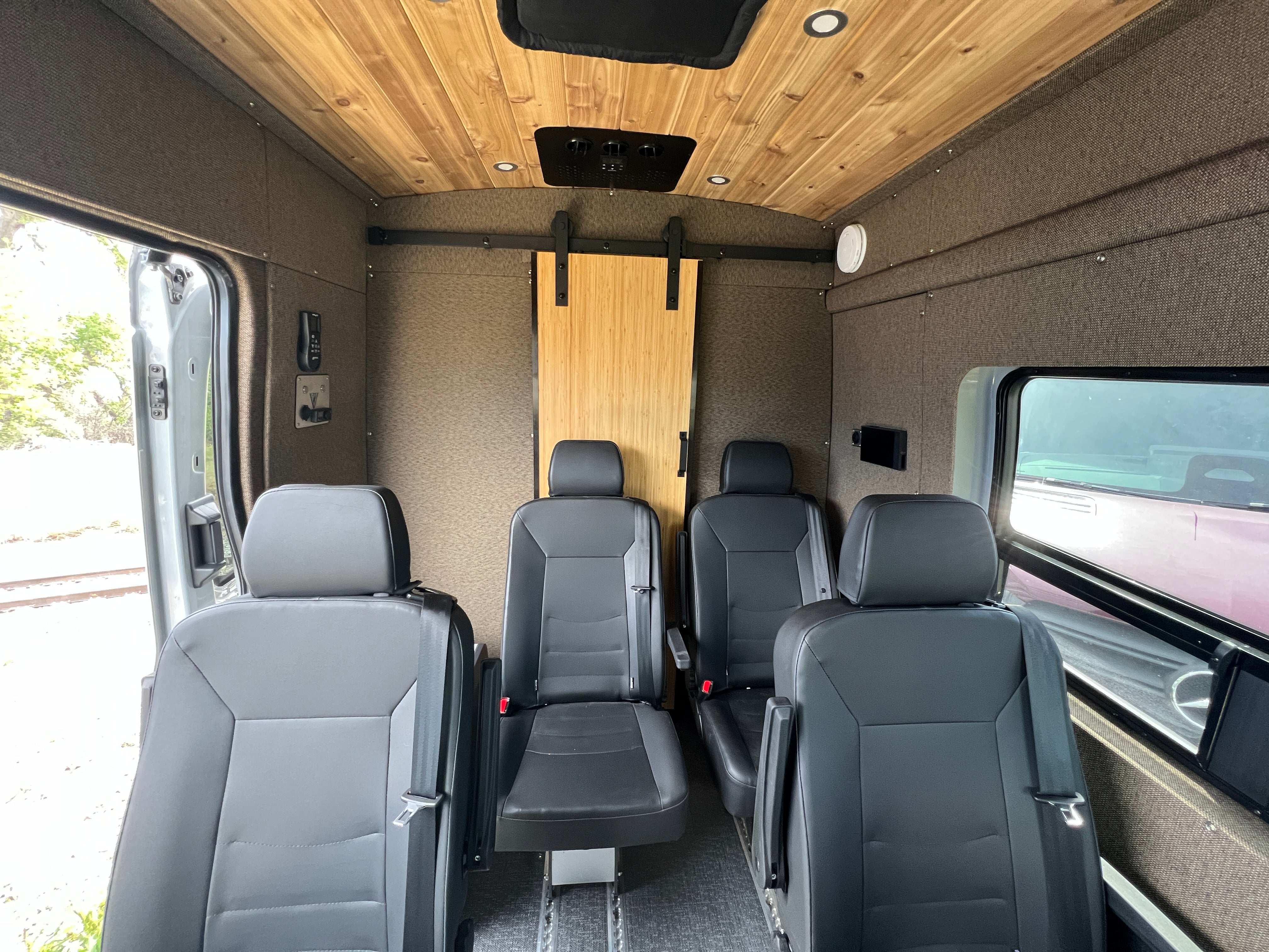 2025 Ford Transit High-Roof rear with spare tire and roof rack