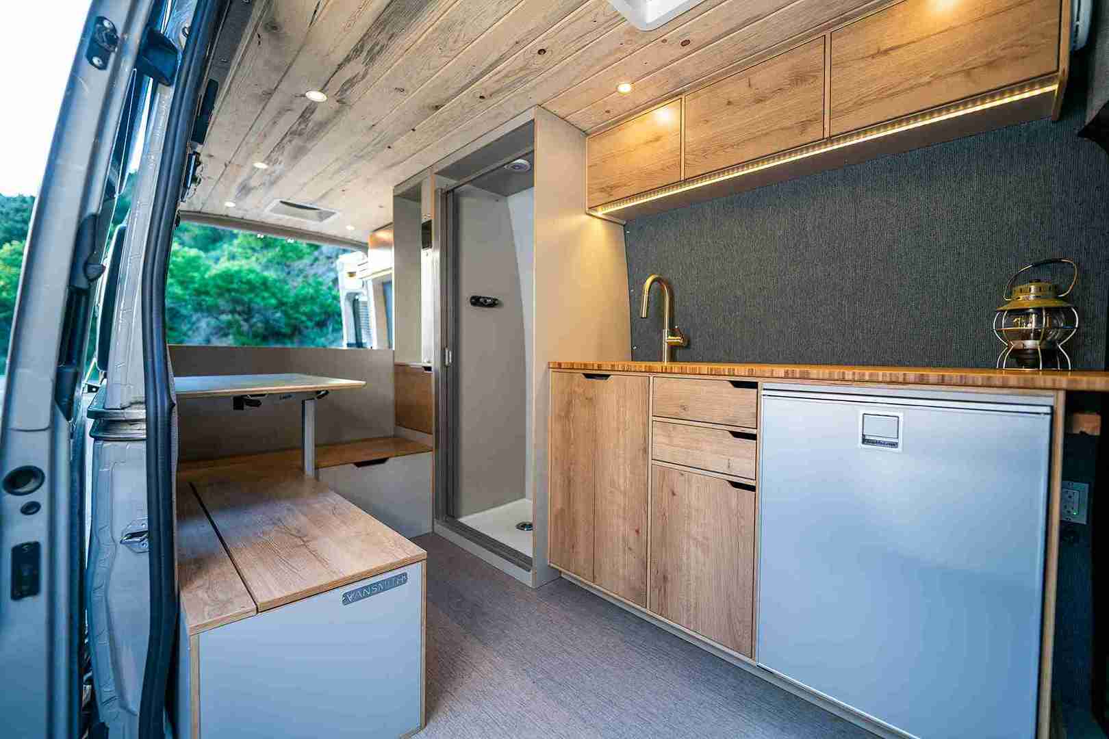 Interior of Sprinter Van Conversion in Colorado by The Vansmith with Luxury Wood Finishes