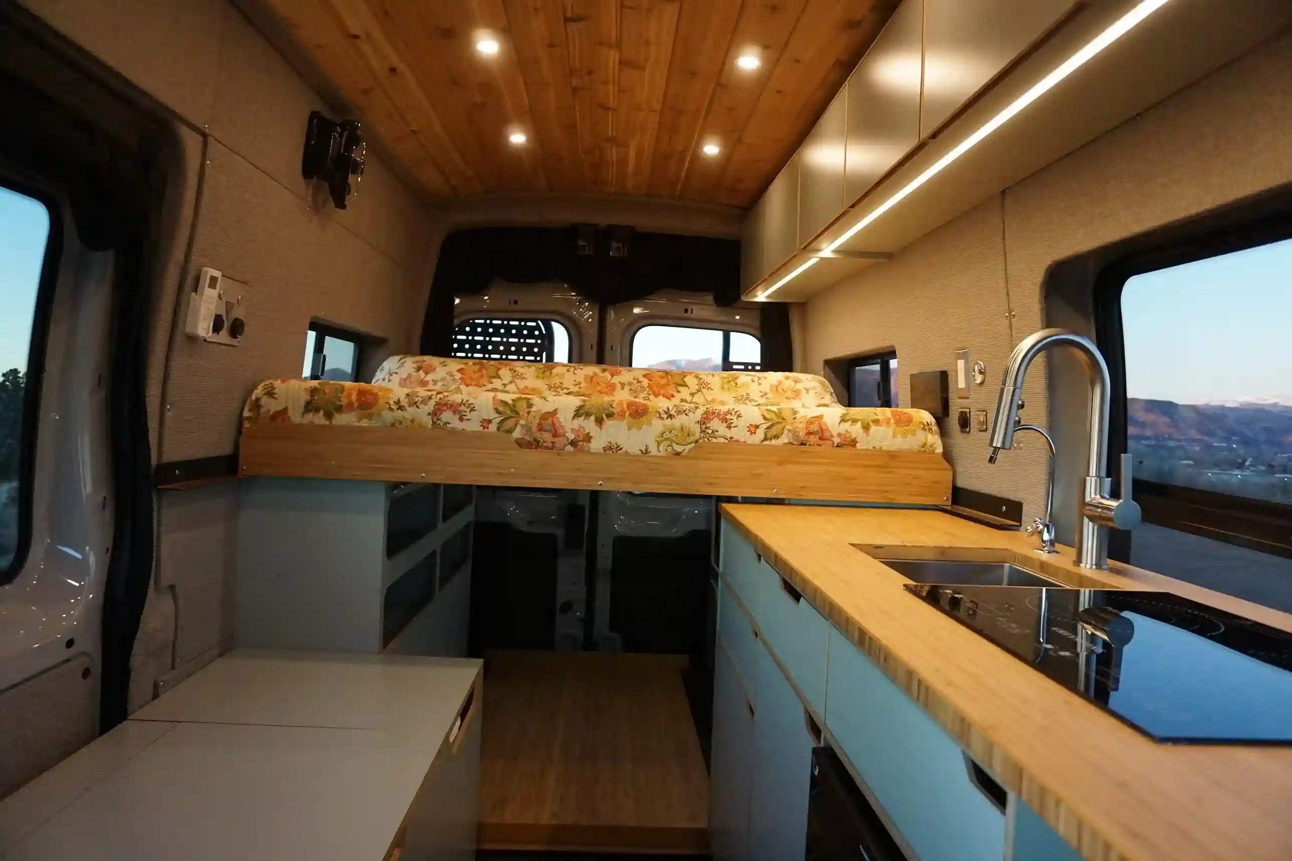 Interior view of van showing bed pushed out on rails for sleeping