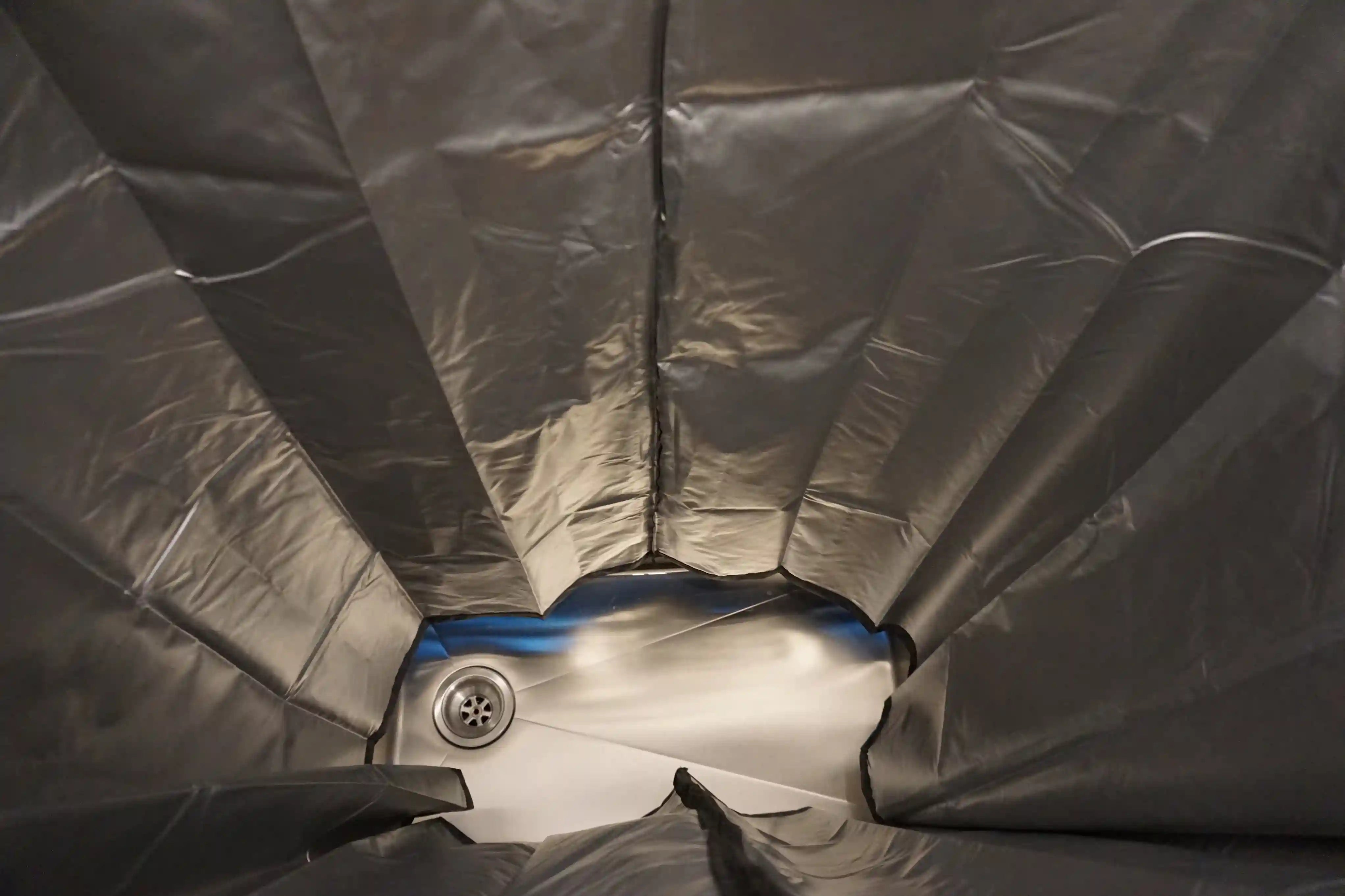 Foldable bench seat in van doubling as shower pan