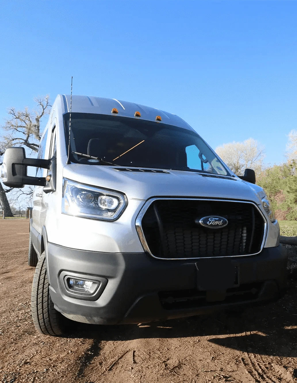 Close-Up Front of Colorado Transit Van Conversion by The Vansmith on Dirt Road
