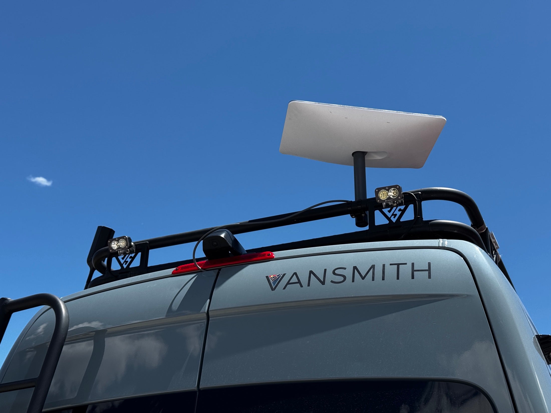 Roof rack with Starlink dish deployed and light bar