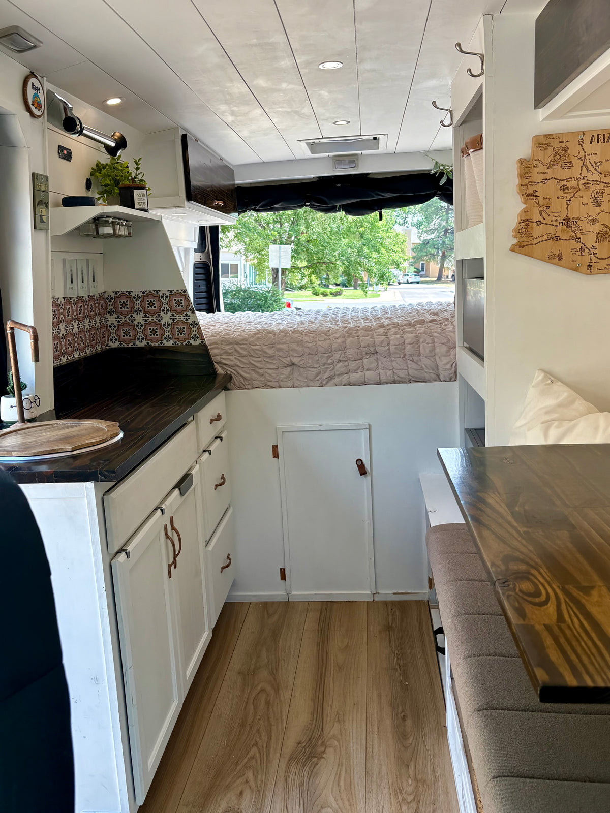 Interior of the ProMaster camper looking toward the rear bed, galley and dinette