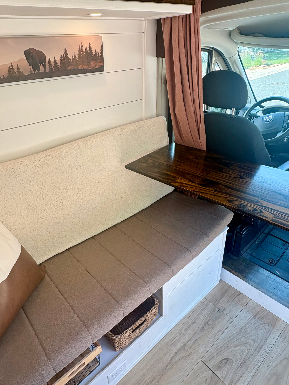 Convertible dinette bench and wood table in the ProMaster camper conversion