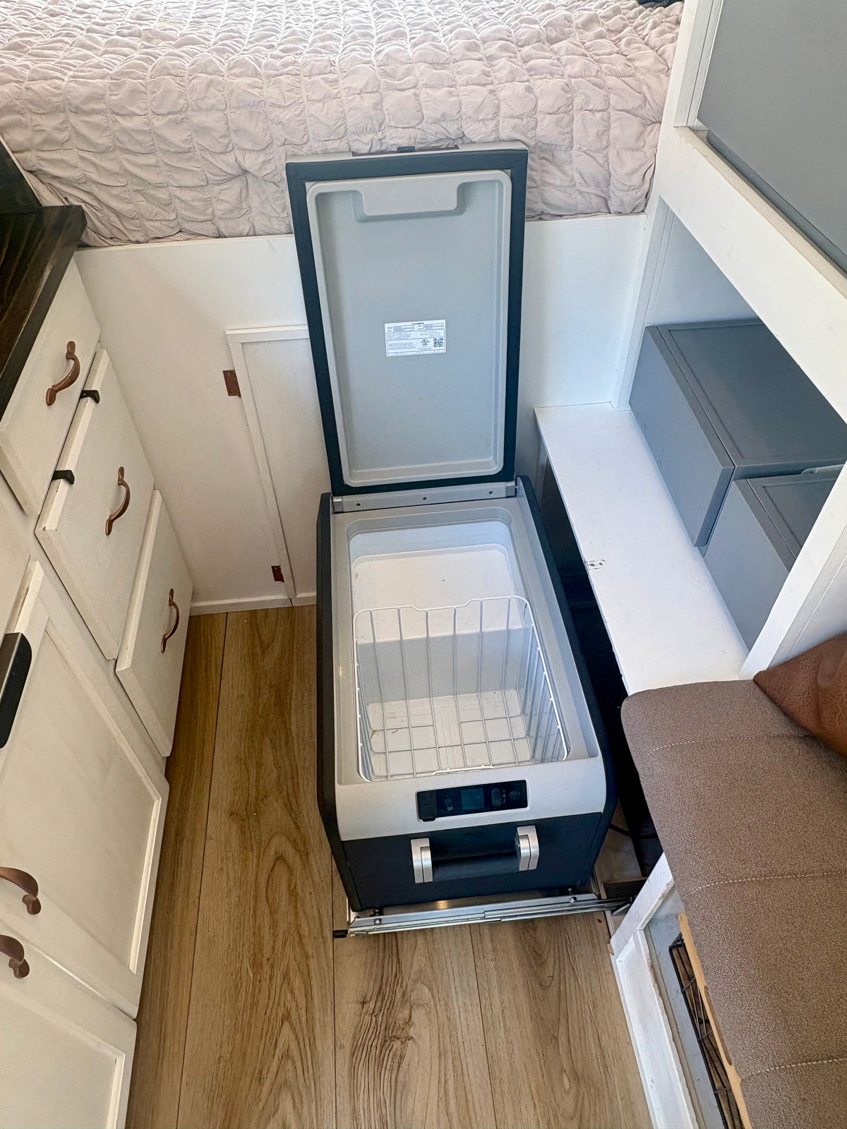 12V compressor fridge on a slide in the ProMaster camper galley