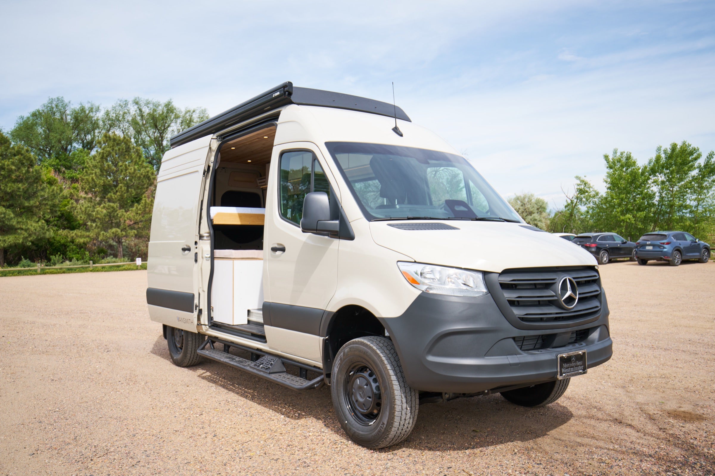 Front three-quarter view of Sprinter Bivy Classic camper van with sliding door open - The Vansmith