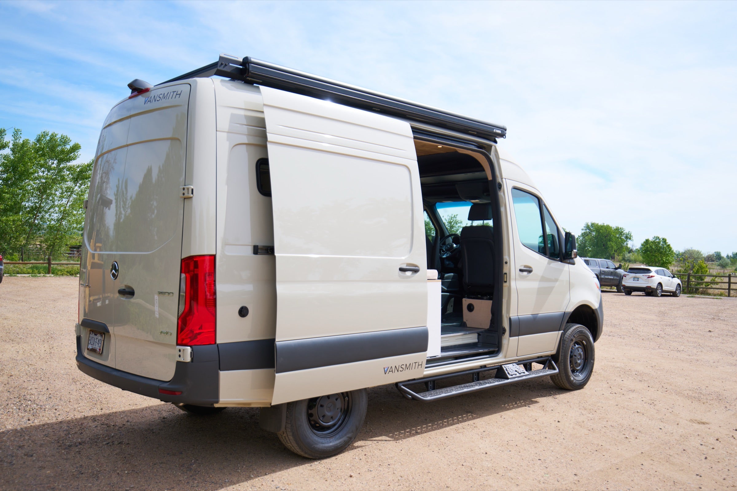 Rear three-quarter view of Sprinter Bivy Classic camper van with sliding door open - The Vansmith