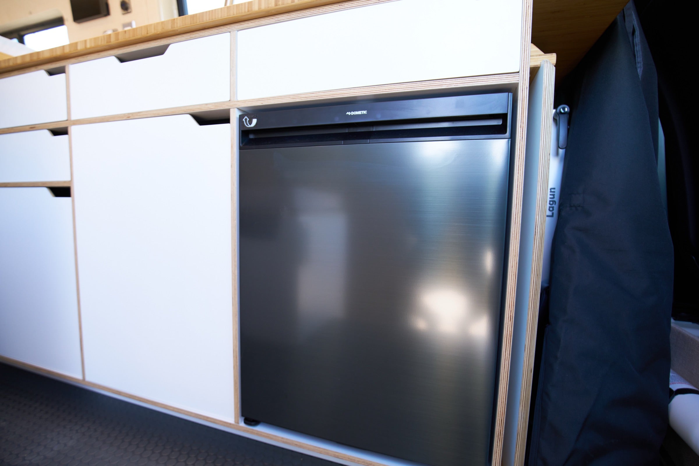 Dometic fridge and cabinetry inside Sprinter Bivy Classic camper van - The Vansmith