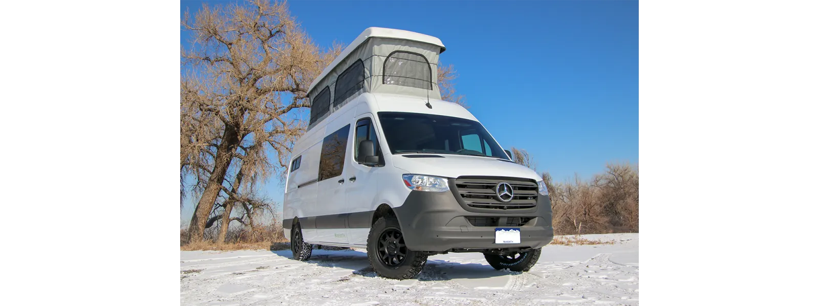 Atlas Sprinter 170 van conversion with poptop roof parked in snow by The Vansmith