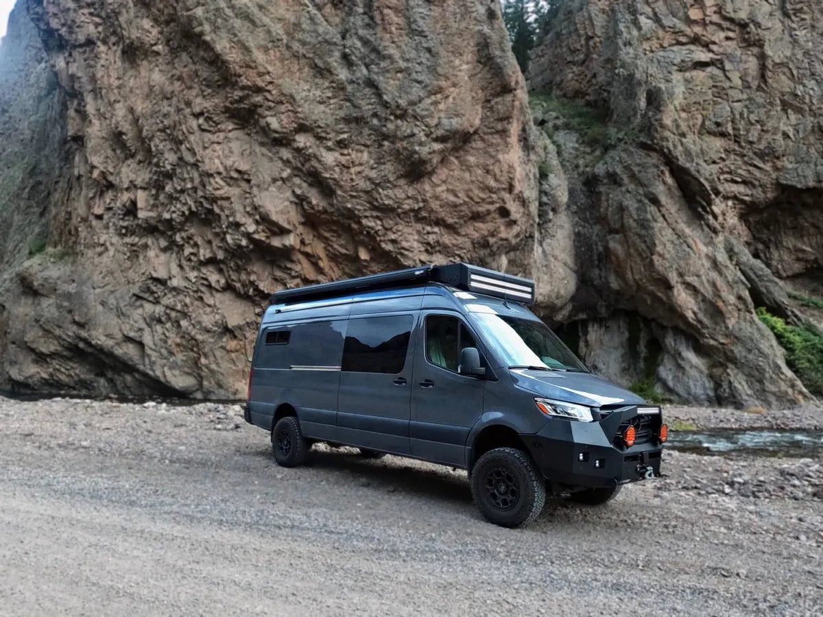 Gray Sprinter van Bamboo build parked at rocky canyon with roof rack by The Vansmith