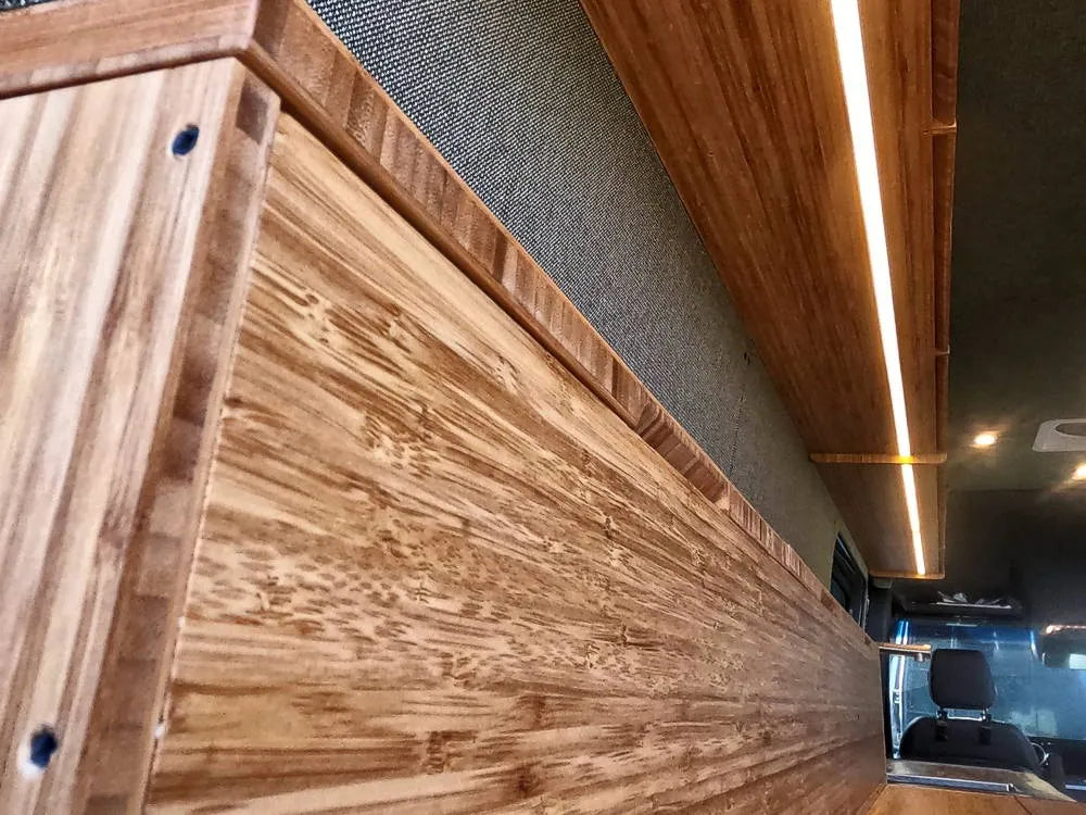 Bamboo cabinet detail showing natural grain woodwork with LED strip lighting by The Vansmith