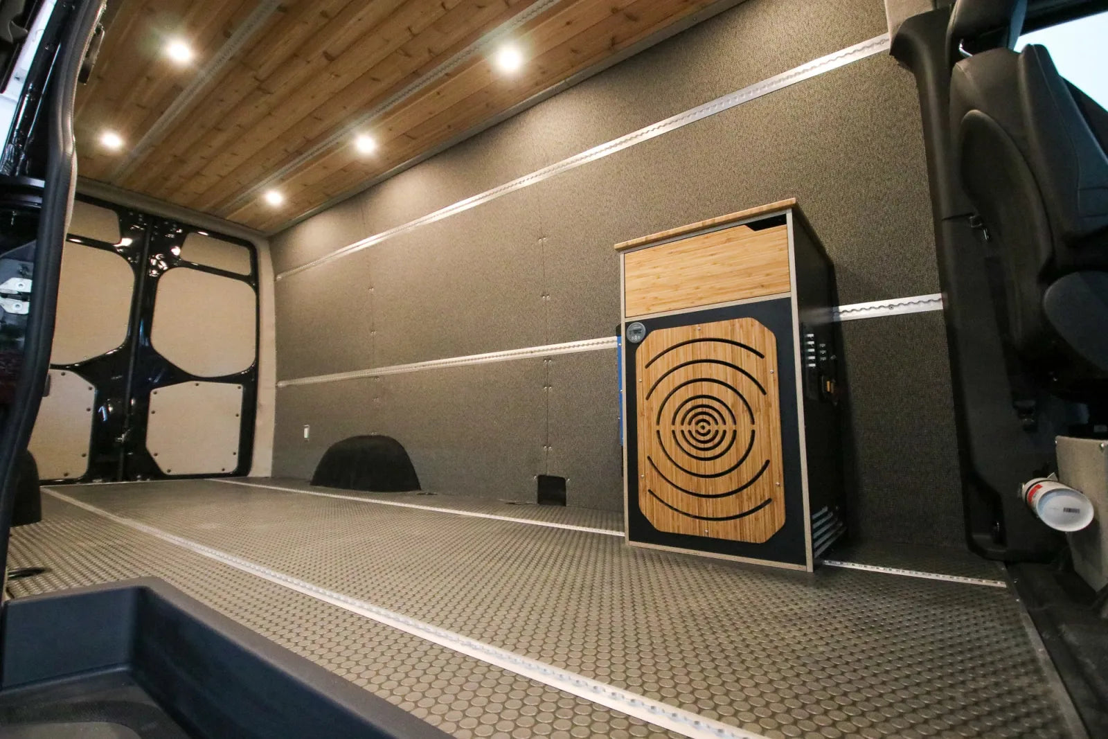 Open cargo space with electrical cabinet and cedar ceiling in Foundation van build