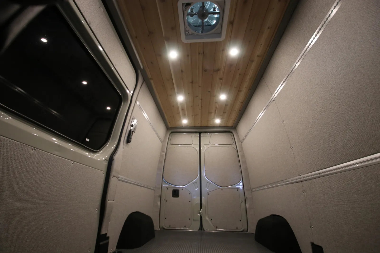 Cedar ceiling, LED lighting, and roof vent fan inside Foundation custom camper van