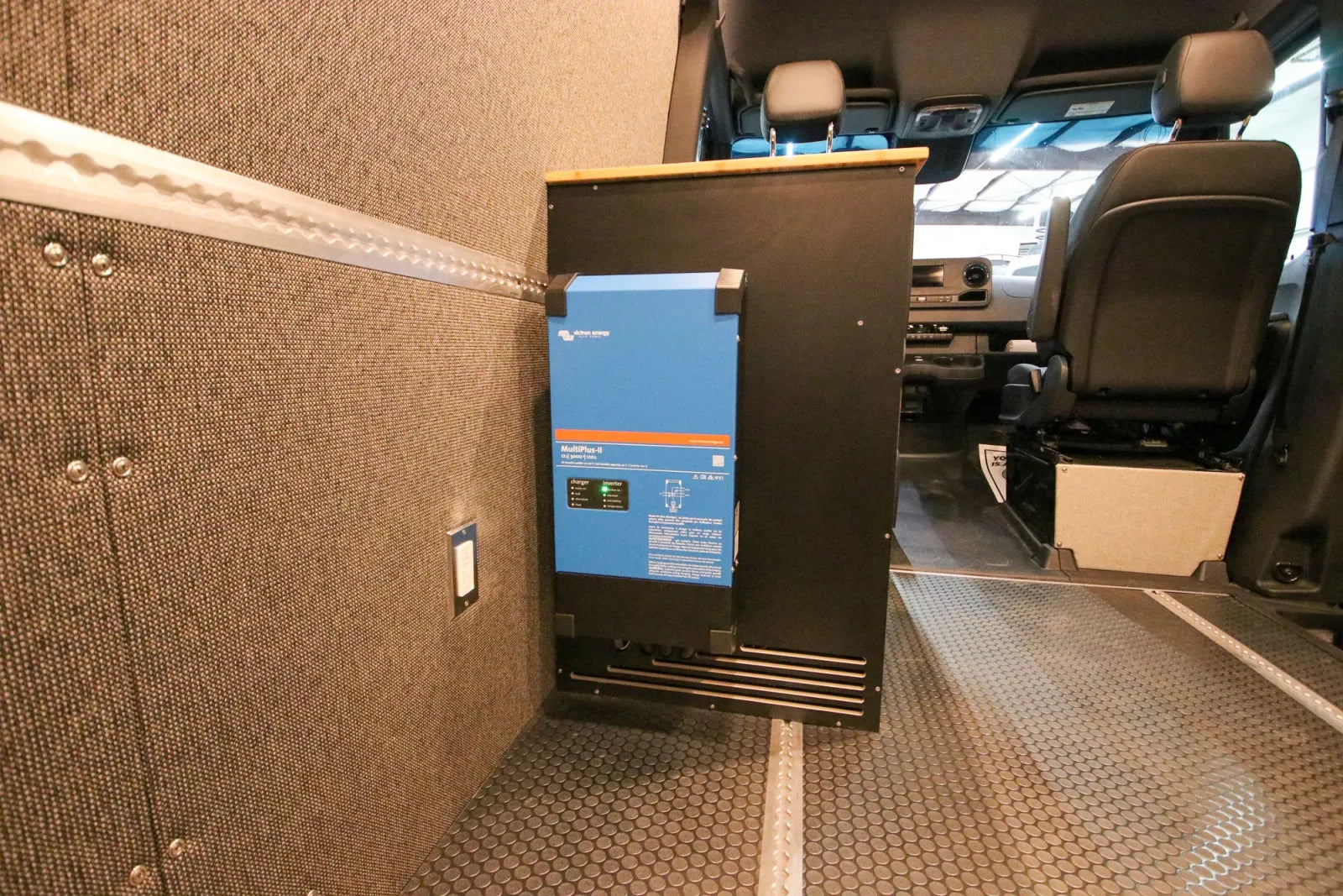 Victron inverter charger mounted on insulated wall in Foundation camper van by The Vansmith