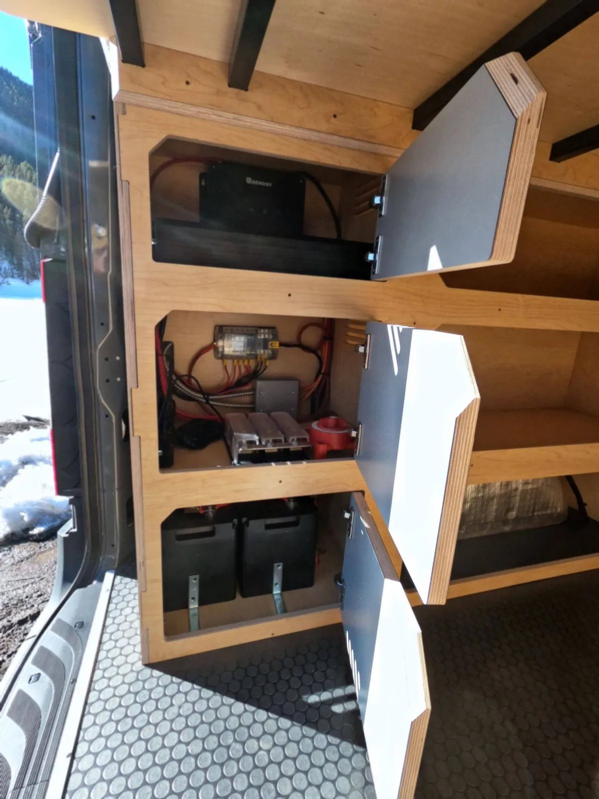 Electrical system with Victron inverter, battery bank, and solar controller in Gina van build