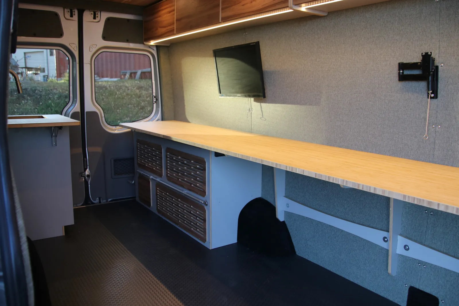 Hustle van conversion long butcher block desk with monitor mount and storage drawers by The Vansmith