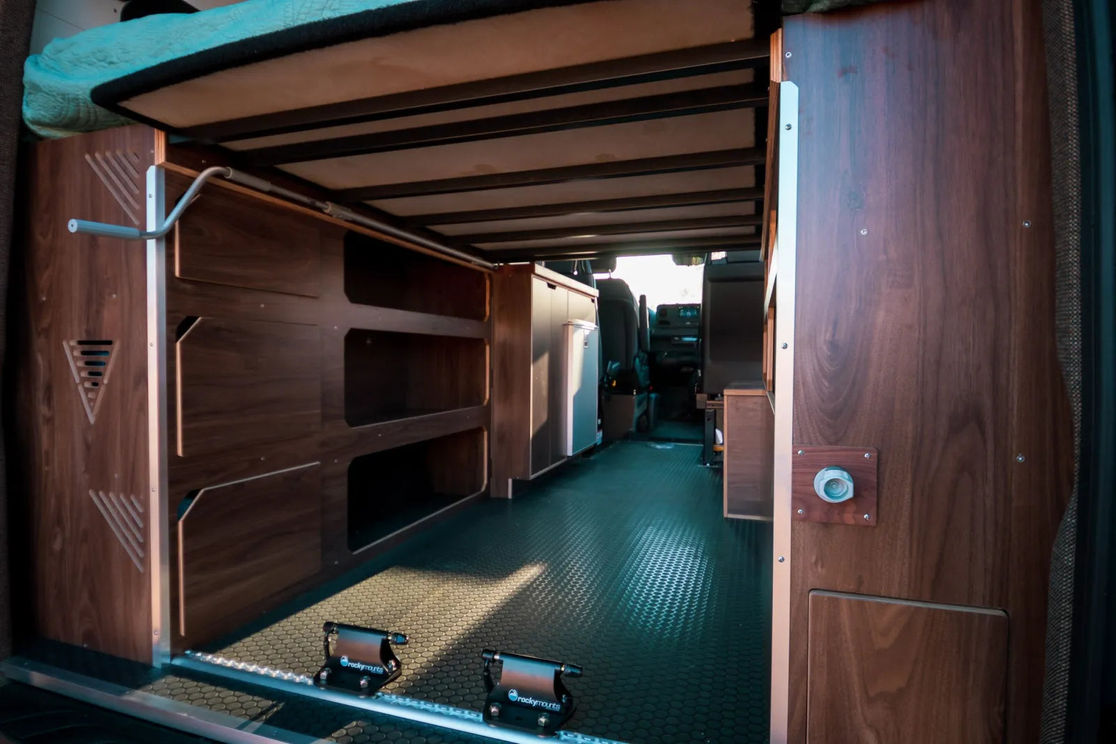 Jimmy van conversion rear garage storage area with walnut shelving and diamond plate floor by The Vansmith