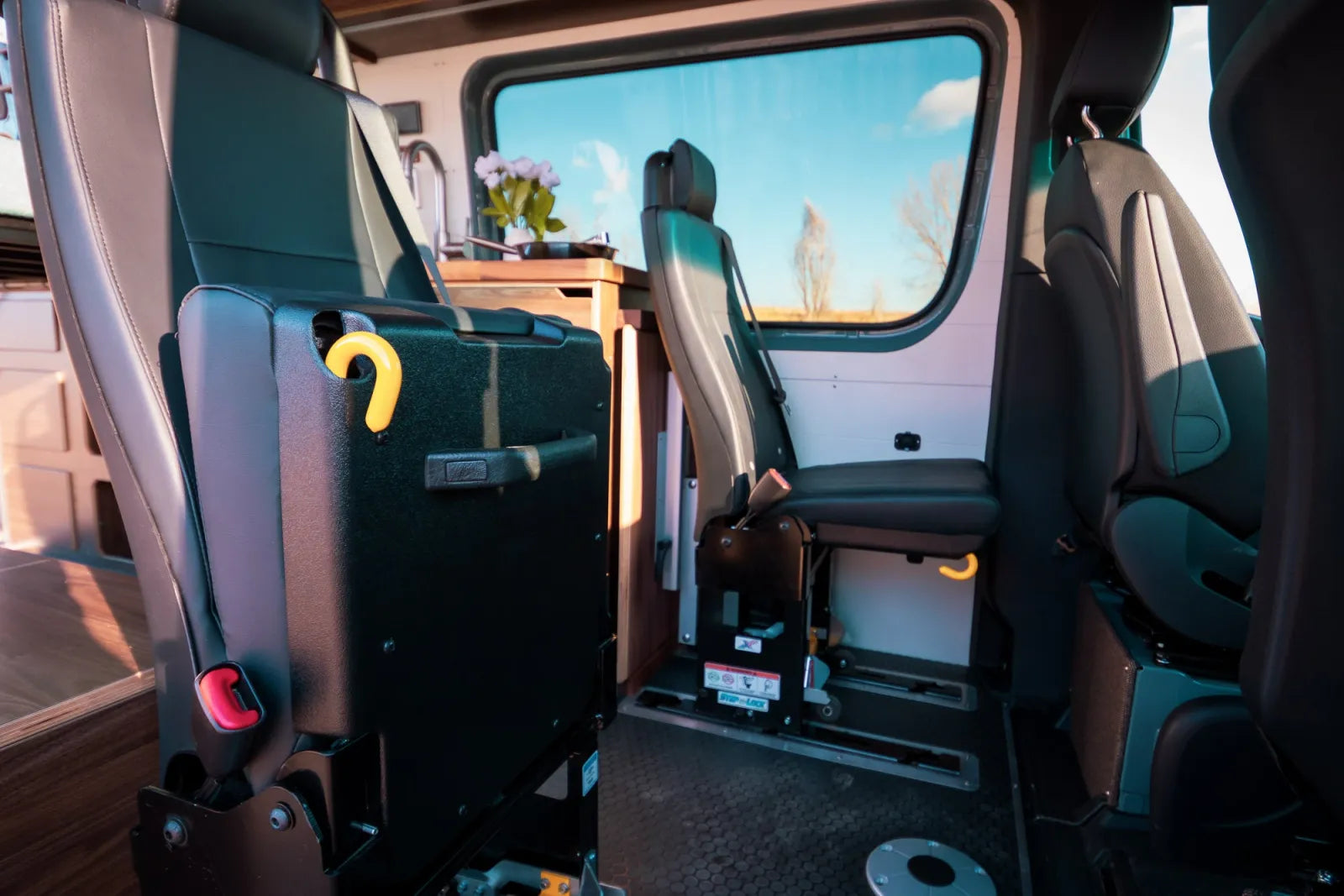 Jimmy Sprinter van fold-down rear seats with butcher block countertop visible by The Vansmith