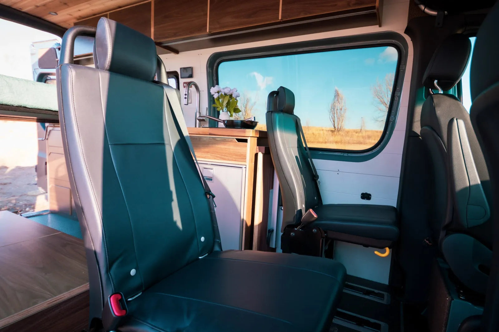 Jimmy van conversion rear passenger seats with teal leather and walnut ceiling by The Vansmith